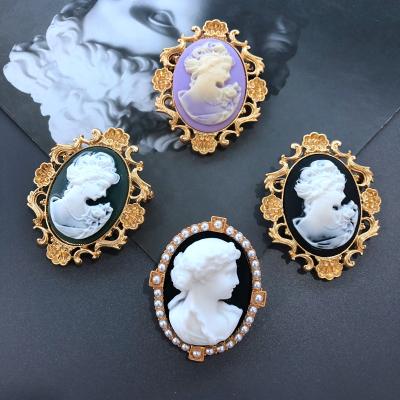 China Other European and American retro pattern art cut-out human head brooch plated matte effect pin real gold inscription m for sale