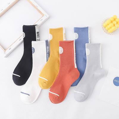 China 2021 Autumn winter trend letter cotton fashion men women basketball sports socks QUICK DRY English socks for sale