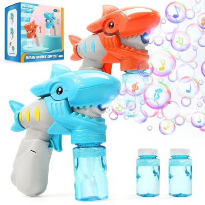 China 2021 Amazon hot sale two color options cute plastic cute ignition and musical shark shape automatic bubble gun for kid for sale