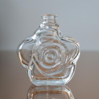 China Custom Durable Embossed Rose Shape Glass Perfume Bottle for sale