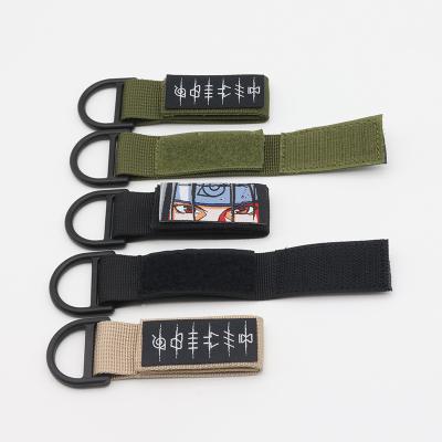 China Promotioanal Gifts / Give Away Cheap Character Customized Anime Logo Army Green Camouflage Outdoor Tactical Backpack Hook Loop Mini Keychain With Woven Label for sale