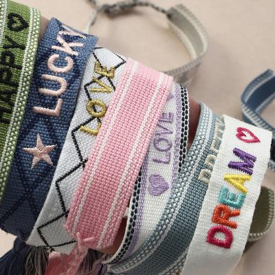 China 2021 TRENDY European and American popular national hand jewelry bohemian style hand letter embroidery tassel woven bracelet for sale