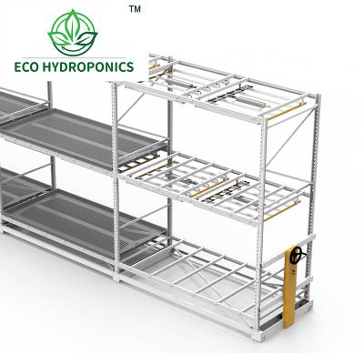 China Movable Multi Level Iron Vertical Ebb And Flow Rolling Bench Rack System With Elevate Tray for sale