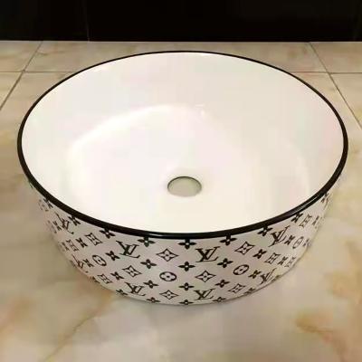 China Modern Luxury European Style Art Single Basin Over Counter Round Modern Design Ceramic Sink Pattern Wash Basin for sale