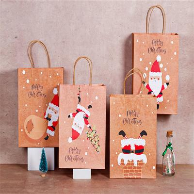 中国 Recyclable Christmas Gift Handbag Santa Elk Portable Gift Paper Bag With Handle Exquisite Christmas Candy Packaging Bag 販売のため