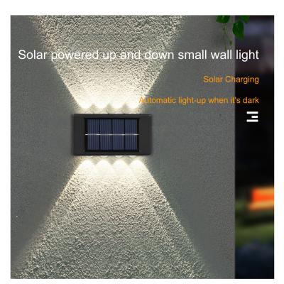 China Glowing Waterproof Atmosphere Wall Light 600mah Solar LED Outdoor Decorative Garden for sale