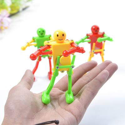 China Toy Cheap Kids Funny Clockwork Early Educational Toys Swinging Mini Robot Wind Up Dancing Toys For Promotion for sale