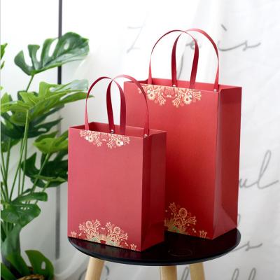 China New Arrival Recyclable Chinese Style Gift Box Packing Bag Rivet Red Festive Paper Bag With Souvenir Packing Gift Bag for sale