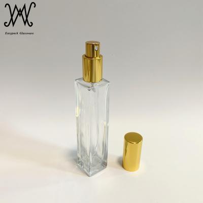 China Personal Care 50ml Clear Rectangle Shape Tall Glass Perfume Bottle With Pump And Sprayer Gold Cap for sale