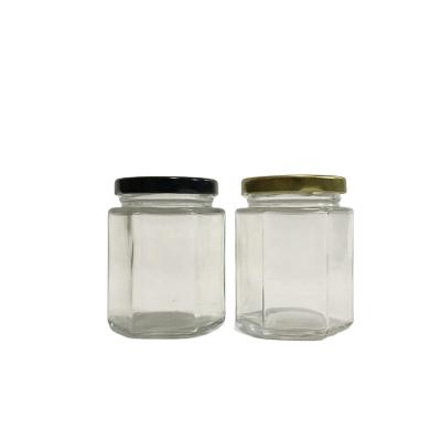 China 6oz 180ml Hexagonal Cover Hex Glass Jar With Twist Off Gold Plastisol Lined Lid for sale