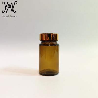 China 75ml Medicine Wide Mouth Amber Glass Medicine Pill Bottle With Gold Metal Lid for sale