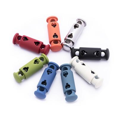 China 2 Hole Press Nickel Free Metal Toggles Stoppers Small Plastic Double Hole Rope Lock for sale