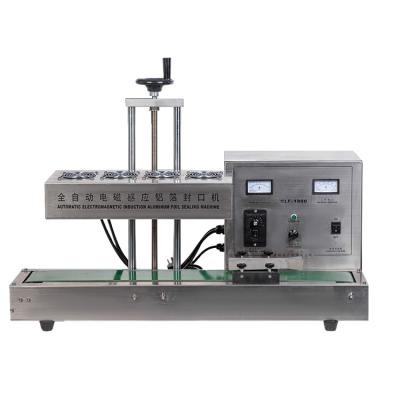 China Hot Food Pressing Aluminum Foil Sealing Machine With Conveyor Belt for sale