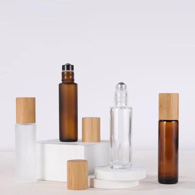 China Clear Amber Frosted Glass Bamboo Cosmetic Empty Lid Essential Oil Roll On Perfume Bottle With Steel Rollerball 5ml 10ml 15ml for sale