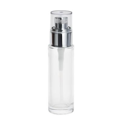 China 30ml 30ml Empty Cosmetic Packaging 1oz Clear Round Glass Base Lotion Cylinder Bottle With Silver Pump Caps for sale