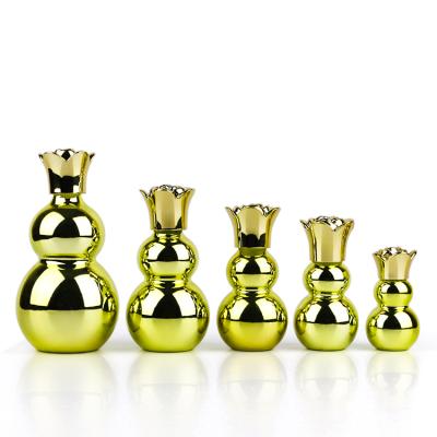 China 10ml 20ml 30ml 50ml 100ml Luxury Modern UV Electroplating Gold Double Squash Serum Empty Glass Bottles With Flower Cap For Essential Oils for sale