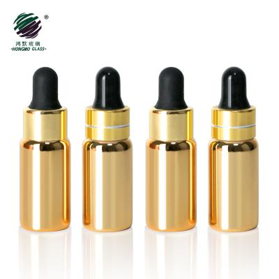 China Personal Care Plating Gold Color 5ml Vials Glass Bottles With Gold Dropper Caps For E Liquid Essential Oil for sale