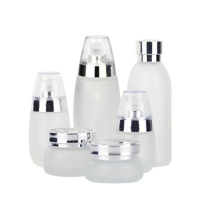 China Luxury Gold Cosmetic Glass Silver Cap Bottle Pump Package Bottle Cosmetic Interesting Looking Empty Lotion Bottle for sale