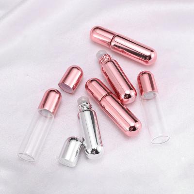 China Cosmetic Available Rose Gold Roll Bottle 5ml UV Empty Essential Oil Glass Bottle With Metal Roll Balls for sale