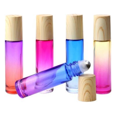 China Customized Roller Bottles Gradient Color 10ml Glass Roller Bottle Cosmetic Essential Oil Bottle With Wood Grain Cover for sale