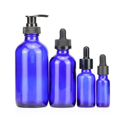 China Eco-friendly 60ml 100ml 150ml 200ml 250ml 300ml 500ml 1000ml Boston Blue Navy Round Glass Shampoo Bottles With Lotion Pump for sale