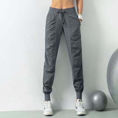 China Running Joggers Women Anti-Wrinkle Fabric Drawstring Sports Gym Fitness Quick Dry Sweatpants With Bilateral Pockets Exercise Pants for sale