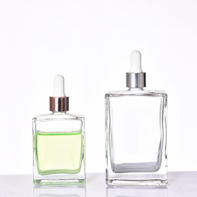 China 30ml 50ml 100ml square style transparent dropper bottle hot wholesale cosmetic skin care flat essence for sale