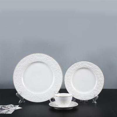 China Sustainable Ware Flower Embossed Gold Rim Coffee Cup Saucer White Charger Plates Wedding Dinner Ware Table Set for sale