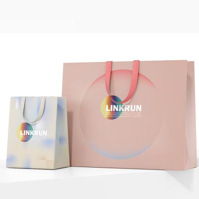 China Recyclable luxury custom logo gold stamping printed white gift paper shopping bags with logos for sale