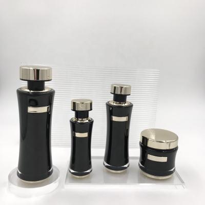 China Factory wholesale custom cosmetic 30ml,50ml,100ml gold empty black cream bottle sleeve pressure presetic pump bottle for sale