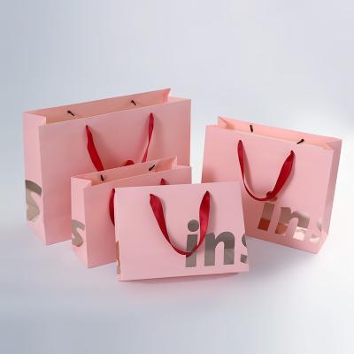 China Recycled Materials Custom Clothes Handle Retail Wedding Goods Boutique Party Kraft Paper Bags Shopping Packaging Paper Bags With Handles for sale