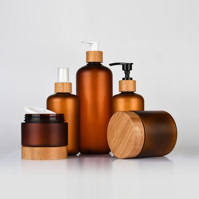 China New arrival boston round plastic bottle shampoo empty plastic bottles amber plastic shampoo bottle with bamboo lid for sale