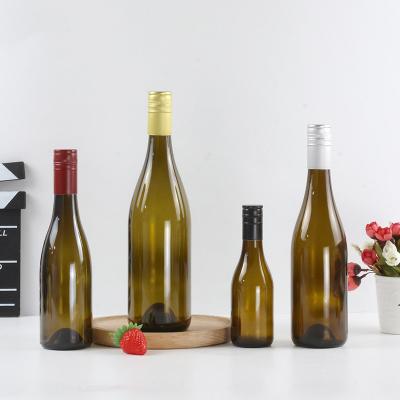 China Food Grade Wholesales Round Amber Empty Bottle 750ml Colored Clear Glass Wine Bottle With Cork for sale