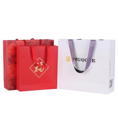 China Recycled Materials Colored Happy New Year Red Practical Design Chinese Lunar Shopping Party Cosmetics Packaging Paper Bags For Gift With Handle for sale