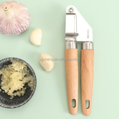 China Sustainable Kitchen Instruments Stainless Steel Garlic Press With Wooden Handle for sale