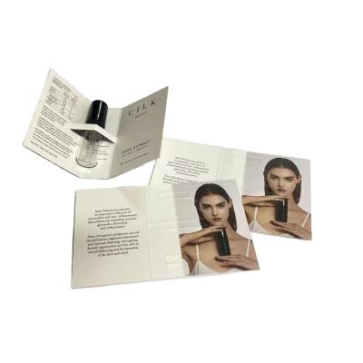 China Perfume Packaging Customized Logo Printing Embossed Paper Perfume Folded Paper Cards for sale