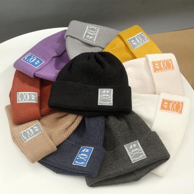 China Custom High Quality Unisex Acrylic Waffle COMMON Skullies Beanie Cap, Plain Dyed Leather Patch Logo Knitted for sale