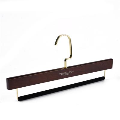 China Customized luxury durable brand slack wood trouser hangers with gold flat hook and velvet back bar for sale