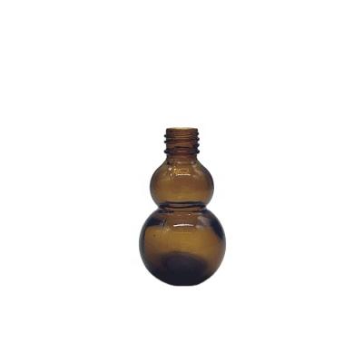 China Personal Care 10ml 20ml 50ml 100ml Amber Calabash Essential Oil Glass Bottle With Dropper for sale