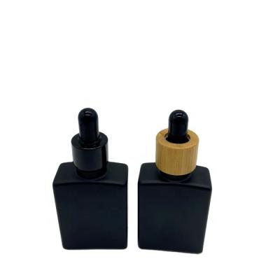 China 15ml 30ml 50ml 100ml Essential Oil Cosmetic Lotion Serum Glass Black Paint Glass Bottle With Dropper Cap for sale