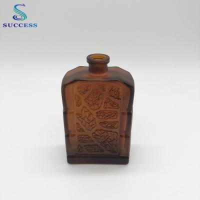 China Personal Care Square Brown 60ml Glass Perfume Bottle With Decorative Pattern for sale