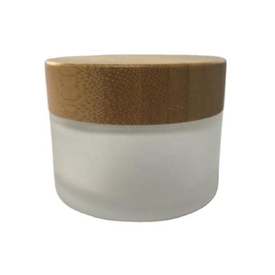 China Popular 100g Skin Care Cream Frosted Glass Jars With Bamboo Lid For Cosmetic for sale