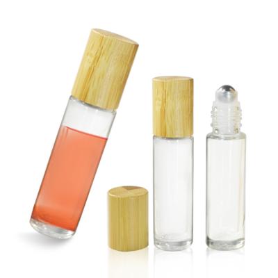 China Multifunctional Wholesale Empty Perfume 10ml Clear Black Glass Roll On Bottle With Bamboo Cap for sale