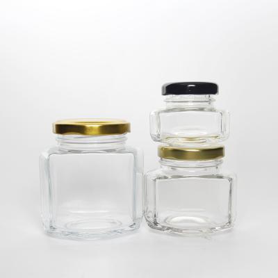 China Hot Sale Unique Design 180ml 270ml Empty Hexagonal Oval Glass Honey Jars Cookie For Jam Food Storage for sale