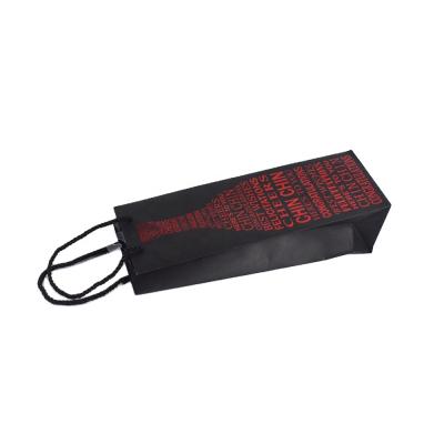 China Recycled Materials Wholesale Black Paper Bottle Bag With Red Hot Stamping And Twist Handle For Packing Wine for sale