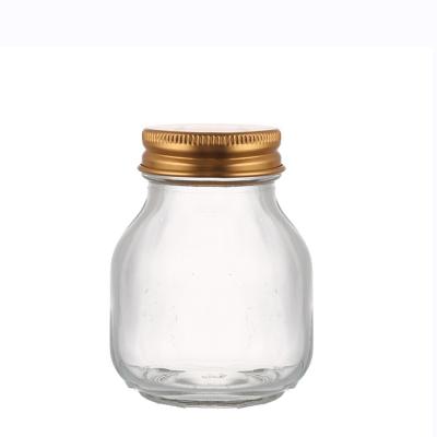 China Custom Unique Viable Shape Storage Transparent 70 ML Birds Nest Glass Jar With Metal Lid for sale