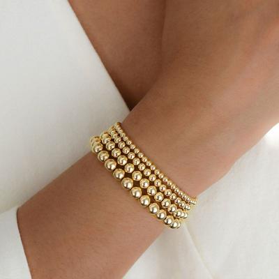 China Environmental Friendly Wholesale Lucky 14k Gold Filled Bead Bracelet Stackable Elastic Bracelet Simple Bead Bracelet Girl for sale