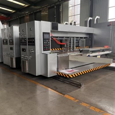 China Leading Edge 2 Colors Ink Flexo Printing Slotting Die Cutting Machinery With Vibration Removal Stacker for sale