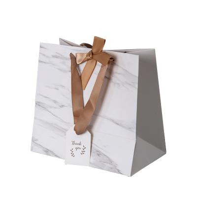 China Modern Recycled Materials Color Art Paper Bag Design Custom White Logo Made Printed Shopping Paper Bag With Ribbon Handles for sale