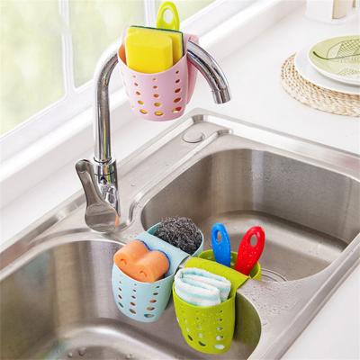 China 2021 New Design Saddle Shape Hanging Basket Kitchen Supplies Drain Tubing Kitchen Sink Viable Storage Basket For Bathroom for sale